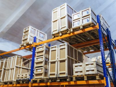 Large trucking warehouse. Wholesale store with cardboard boxes. Rows of shelves with paper containers. Large factory. Storehouse interior